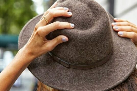 Mãos femininas segurando chapéu